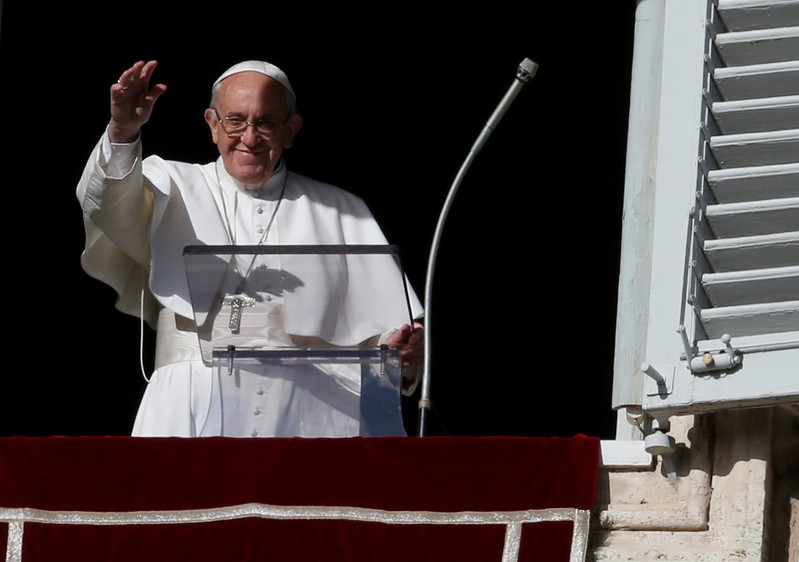 Pope Francis waves during his Sunday Angelus prayer, on the day of his birthday, in Saint Peter's square at the Vatican