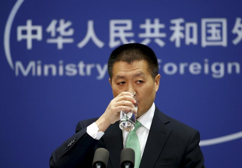 Chinese Foreign Ministry spokesman Lu Kang drinks a cup of water at a regular news conference in Beijing
