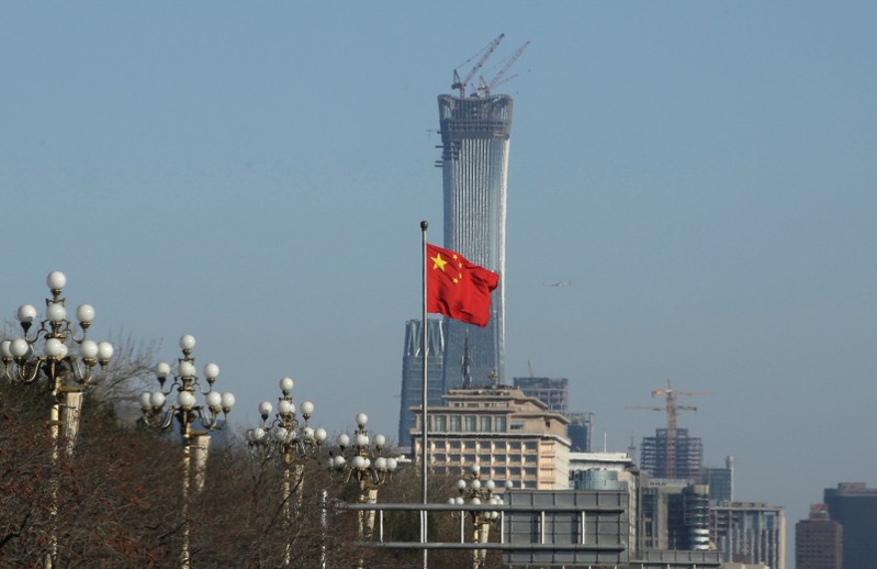 A Chinese flag flutters at Xinhuamen Gate of Zhongnanhai leadership compound in central Beijing