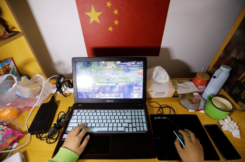 A student majoring esports and management practices on her laptop in a dormitory at the Sichuan Film and Television University in Chengdu