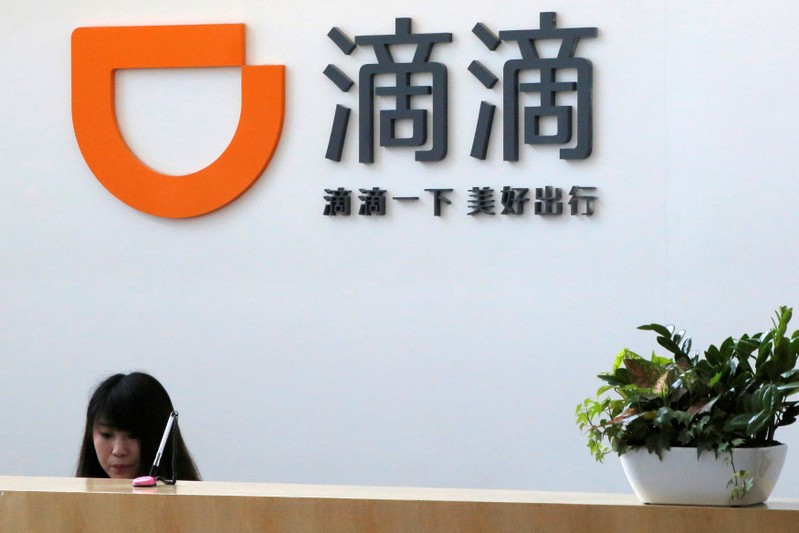 FILE PHOTO: A woman works at the reception of Didi Chuxing at its headquarters in Beijing