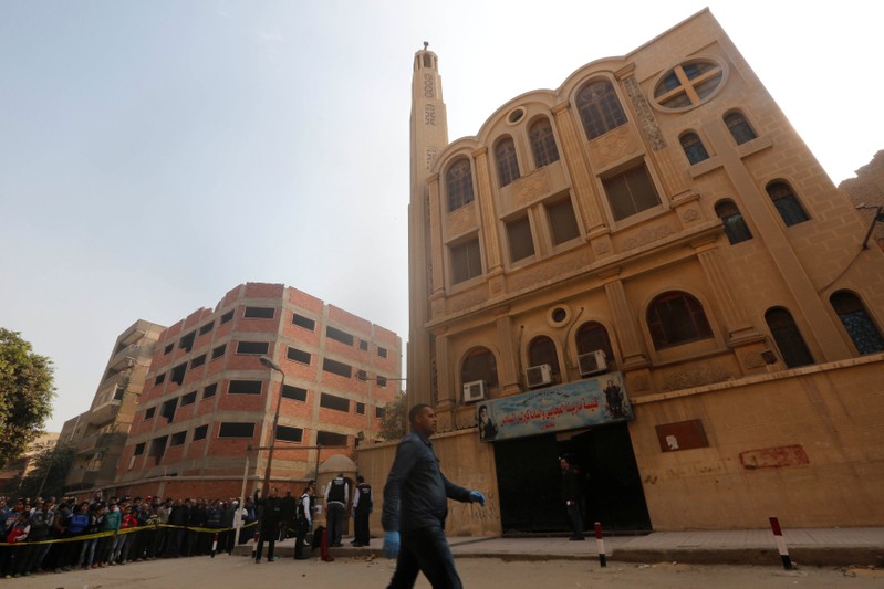 FILE PHOTO: Policemen inspect the site of attack on Mar Mina church in Helwan district on the outskirts of Cairo