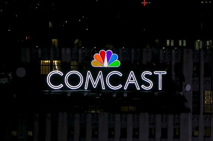 FILE PHOTO - The NBC and Comcast logo are displayed on top of 30 Rockefeller Plaza, formerly known as the GE building, in midtown Manhattan in New York