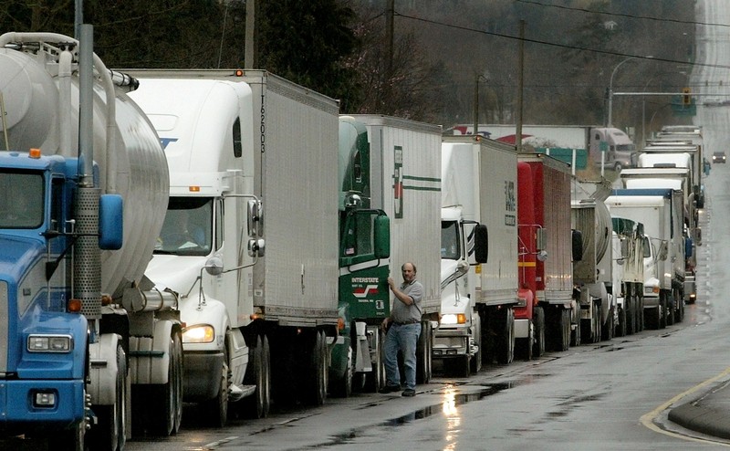 FILE PHOTO - Trucks waiting to cross the Canadain border into the United States line up in Surrey, British Columbia