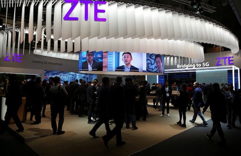 FILE PHOTO: People stand at ZTE's booth during Mobile World Congress in Barcelona