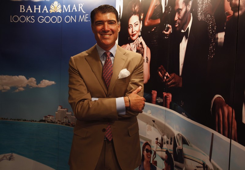 Baha Mar's Chairman and CEO Izmirlian poses in front of a counter promoting Bahamian Riviera resort during the Global Gaming Expo Asia in Macauduring Global Gaming Expo Asia in Macau