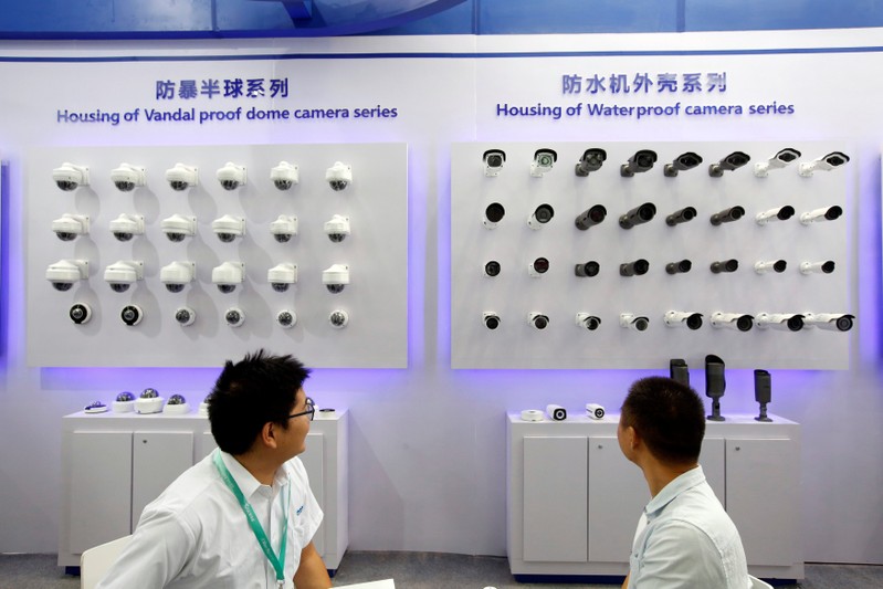 A manufacturer displays camera housing during the China Public Security Expo in Shenzhen