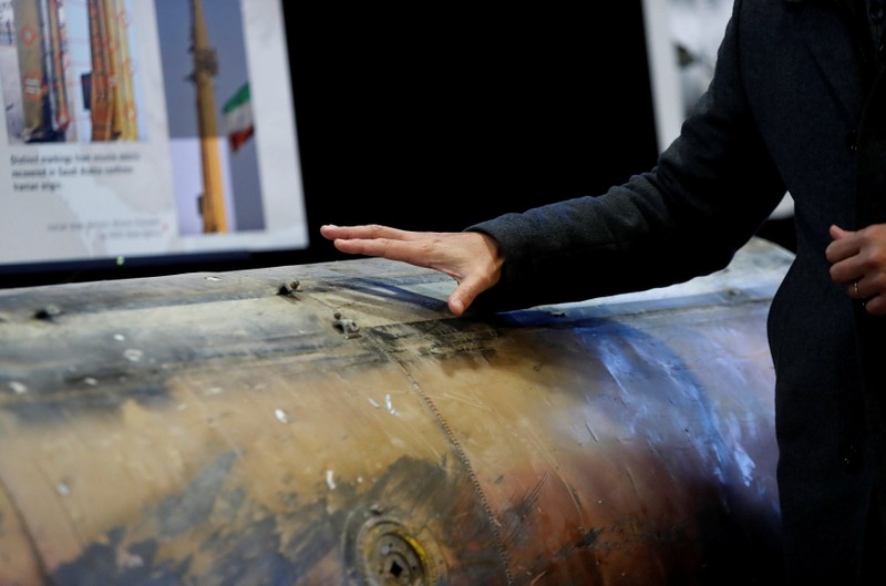 Journalist touches missile that the U.S. Defense Department says was manufactured in Iran and fired into Saudi Arabia by Houthi rebels on display at military base in Washington