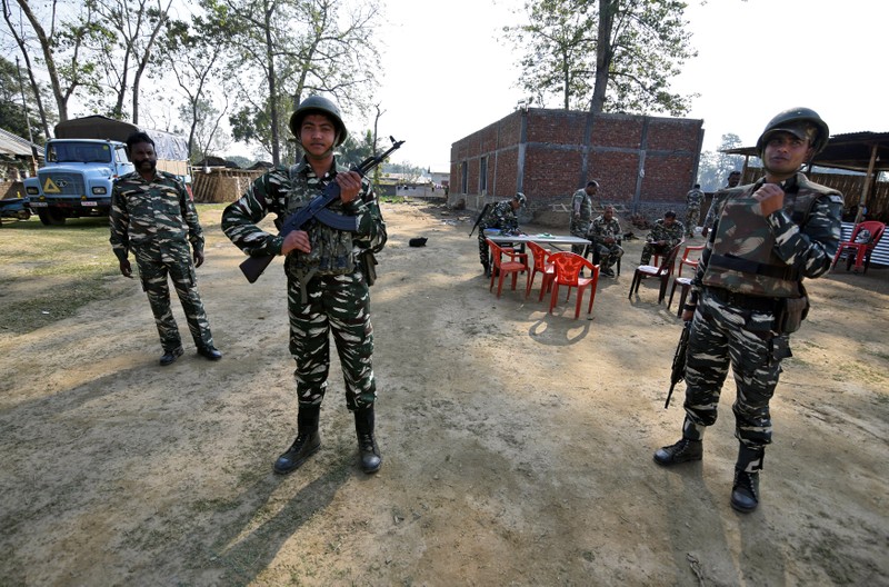 CRPF personnel stand guard at a temporary camp ahead of the publication of the first draft of the National Register of Citizens in the Juria village of Nagaon district