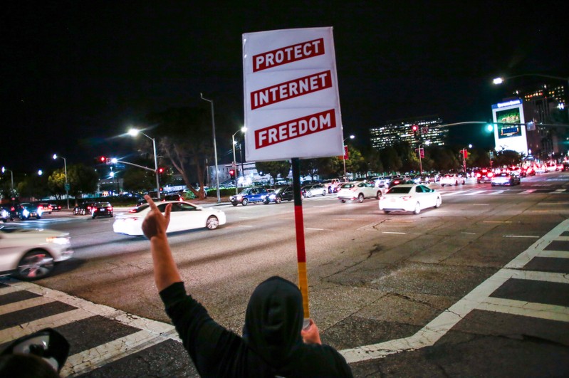 A supporter of Net Neutrality protests the FCC's recent decision to repeal the program in Los Angeles