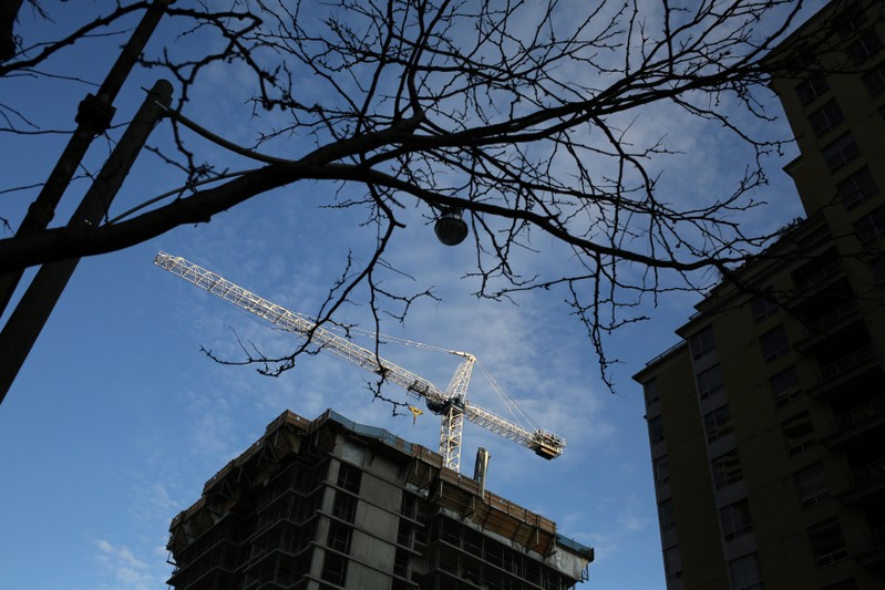 FILE PHOTO - A crane towers over a condominium construction site in Toronto