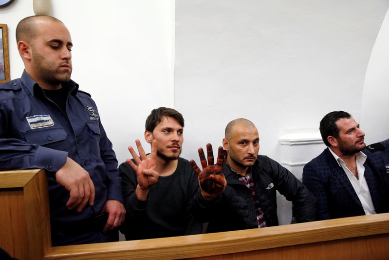 Three Turkish tourist whom Israeli authorities have arrested in Jerusalem over an incident that followed Muslim prayers at a flashpoint holy site according to a police spokesman, gesture at court in Jerusalem