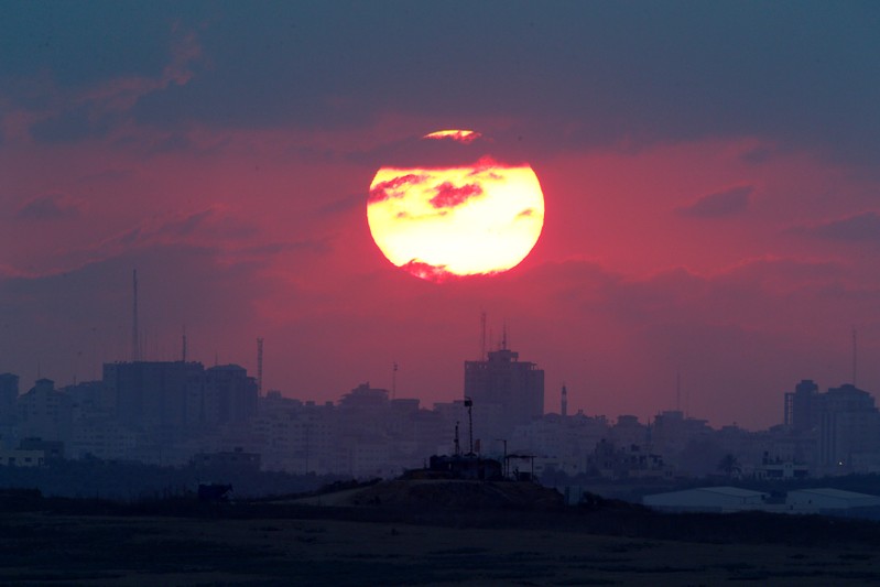 FILE PHOTO: The sun sets over the Gaza Strip, as seen from the Israeli side