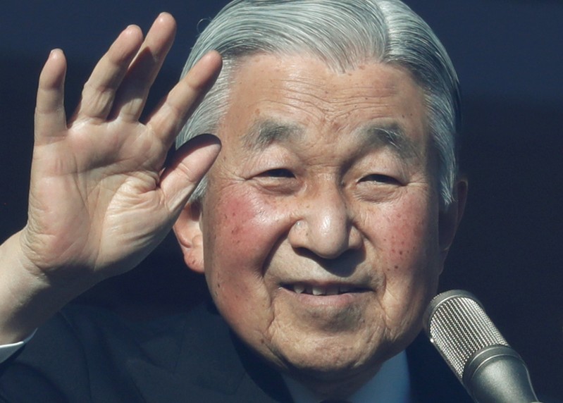Japan's Emperor Akihito waves to well-wishers who gathered at the Imperial Palace to mark his 84th birthday in Tokyo