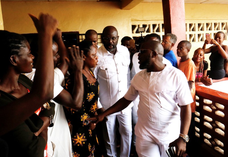 George Weah, former soccer player and presidential candidate of Congress for Democratic Change (CDC), arrives to cast his ballot during presidential elections at a polling station in Monrovia