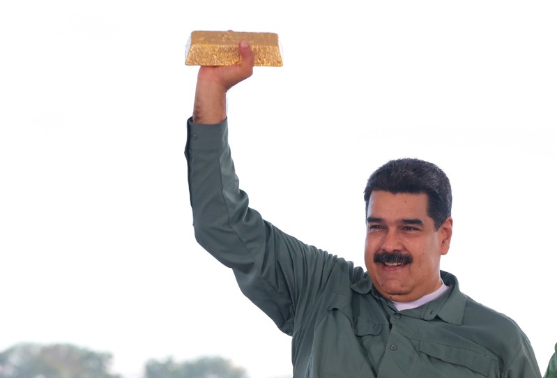 Venezuela's President Maduro holds a gold bar during a meeting with representatives of the mining sector in Puerto Ordaz