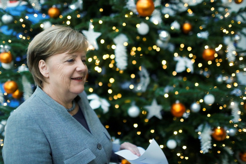 FILE PHOTO: Acting German Chancellor Angela Merkel leaves after a news conference at the Christian Democratic Union (CDU) party headquarters in Berlin