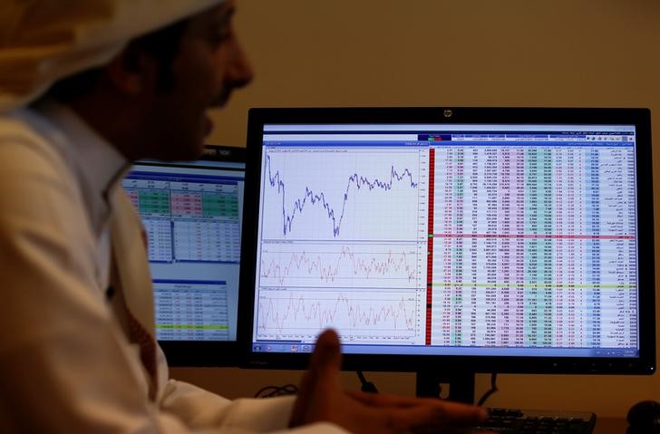 An investor gestures as he monitors a screen displaying stock information in Riyadh