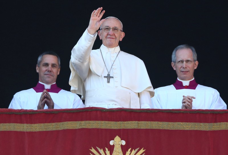Pope Francis waves as he leads the 