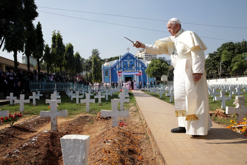 Pope Francis walks through the cemetery at the Church of the Holy Rosary in Dhaka