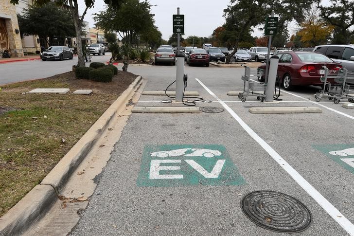 FILE PHOTO - An electric vehicle fast charging station is seen in the parking lot of a Whole Foods Market in Austin