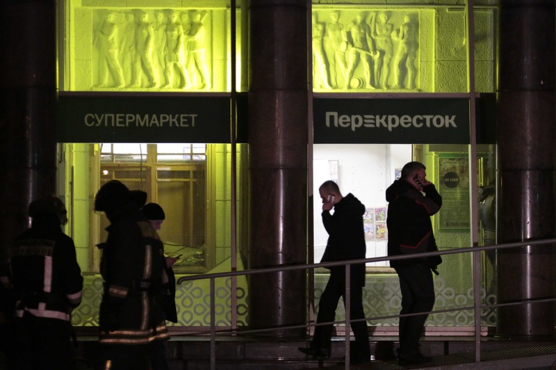 People gather outside a supermarket after an explosion in St Petersburg