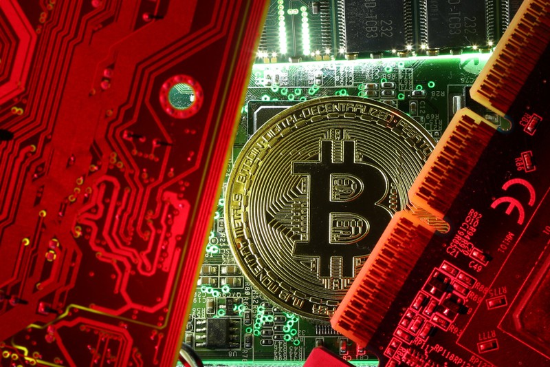 FILE PHOTO: A coin representing the bitcoin cryptocurrency is seen on computer circuit boards in this illustration picture