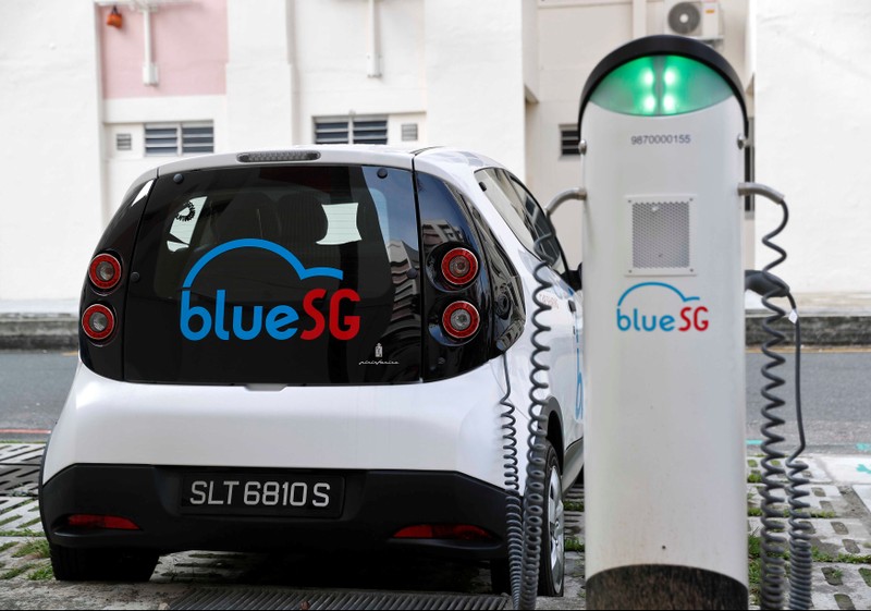 A BlueSG electric car-sharing vehicle is parked at a charging station in a public housing estate in Singapore