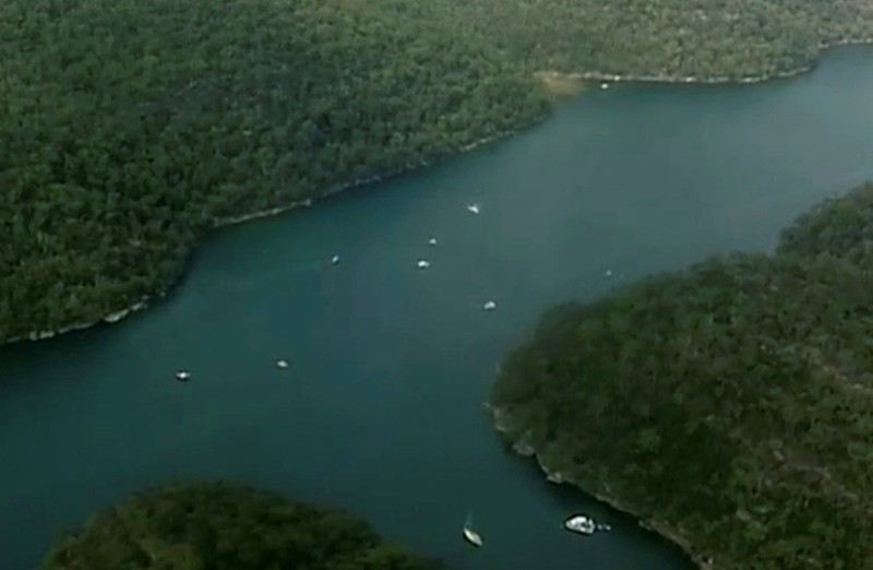 Aerial shot of emergency vessels in water after a seaplane crashed into a Sydney river