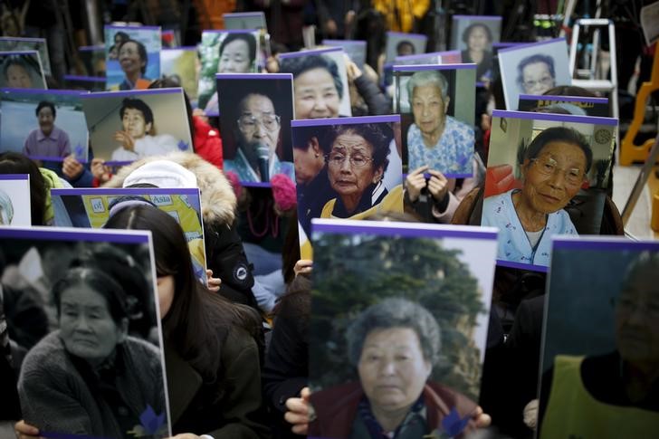 Students hold portraits of deceased former South Korean 