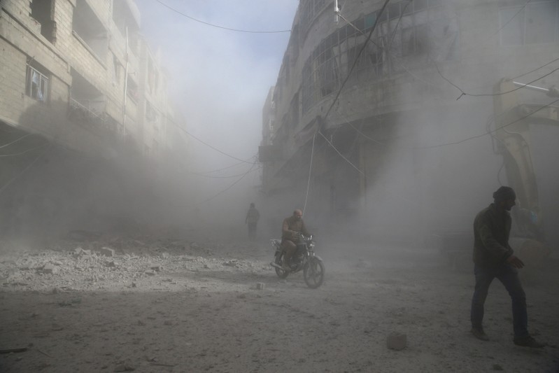 People are seen during shelling in the town of Hamoria