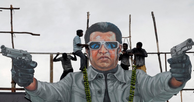 FILE PHOTO - Fans of south Indian film star Rajinikanth pour milk as an offering over his cut-out on the release date of his new movie 