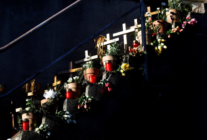 FILE PHOTO: Crosses and flowers lie at a memorial remembering the victims of the stampede at Love Parade techno festival 2010 in Duisburg