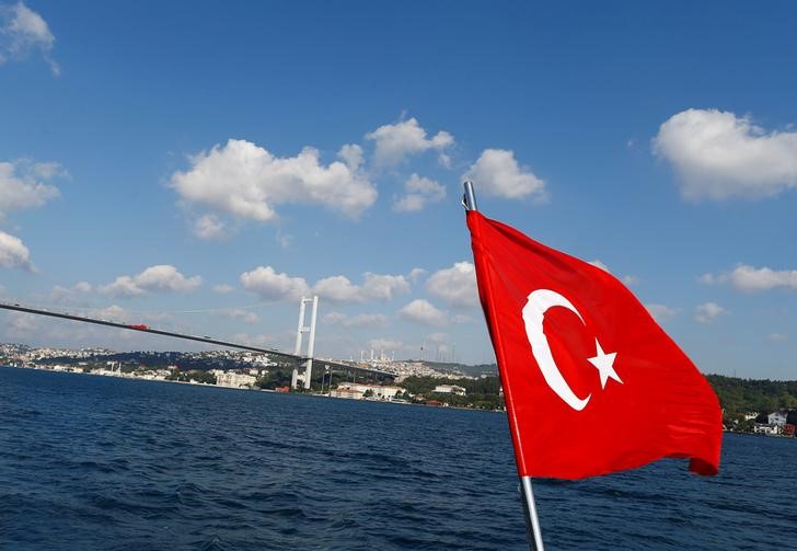 A Turkish flag is pictured on a boat with the Bosphorus bridge in the background in Istanbul