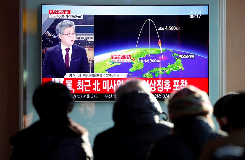 People watch a television broadcast of a news report in Seoul on North Korea firing what appeared to be an ICBM that landed close to Japan