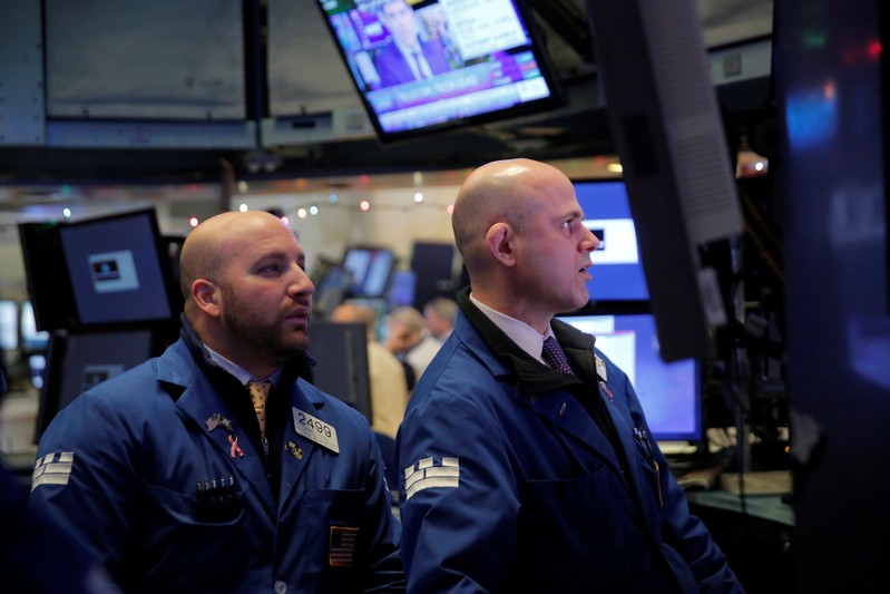 Traders work on the floor at the New York Stock Exchange (NYSE) in Manhattan, New York