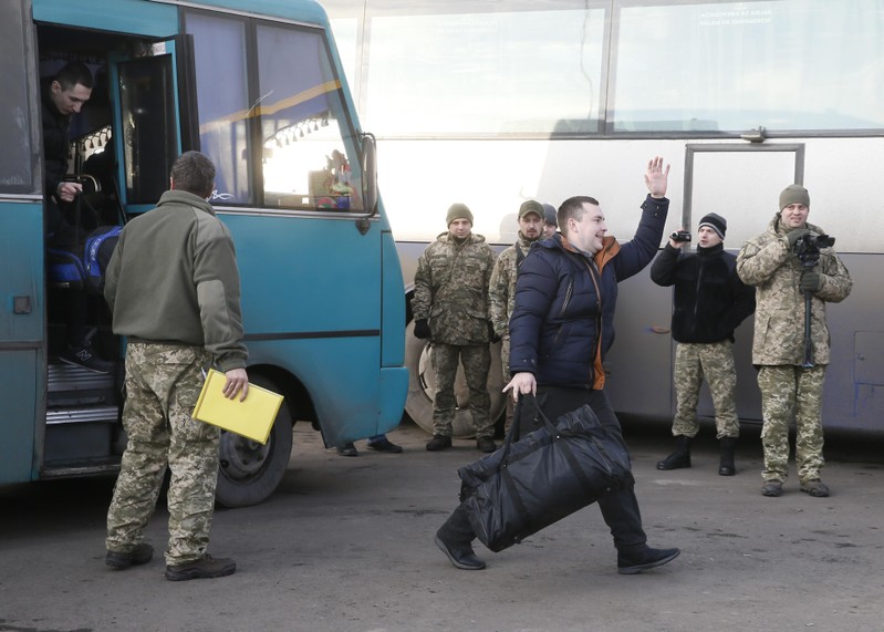 A prisoner of war from the Ukrainian armed forces reacts after leaving a bus during the exchange of captives in Donetsk region