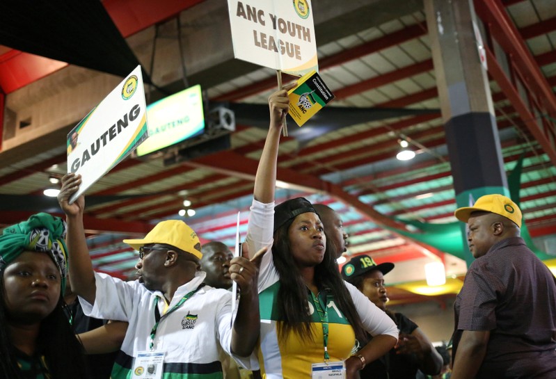 ANC members hold placards at the 54th National Conference of the ruling African National Congress (ANC) at the Nasrec Expo Centre in Johannesburg, South Africa
