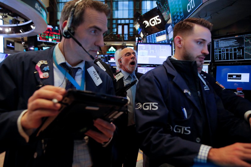Traders work on the floor at the New York Stock Exchange (NYSE) in Manhattan, New York