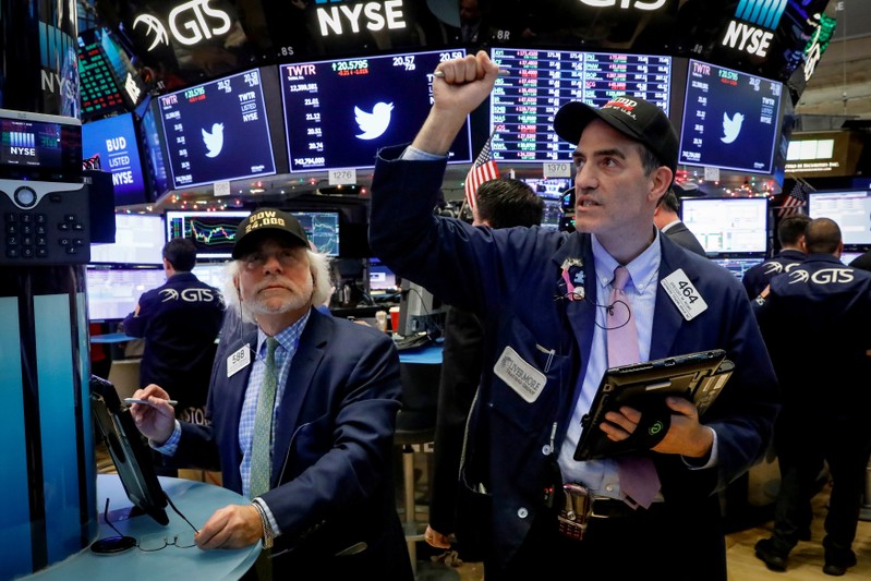 FILE PHOTO: Traders react at the closing bell on the floor of the NYSE in New York