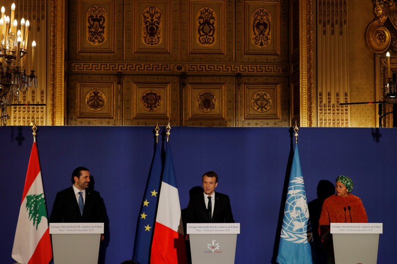 French President Emmanuel Macron stands between Lebanon's Prime Minister Saad al-Hariri and UN Deputy Secretary General Amina Mohammed as they attend the Lebanon International Support Group meeting in Paris