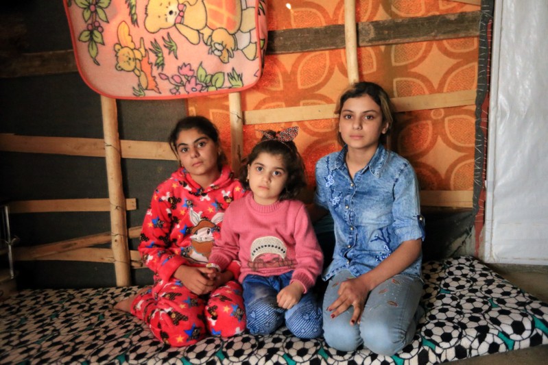 Yazidi girls who were reunited with their family after being enslaved by IS pose at Sharya Camp in Duhuk