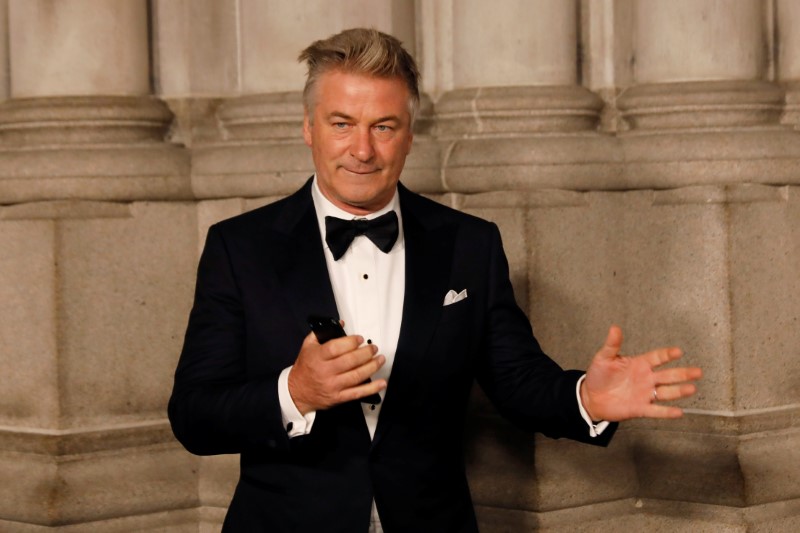 Actor Alec Baldwin gestures before walking on the red carpet during the commemoration of the Elton John AIDS Foundation 25th year fall gala at the Cathedral of St. John the Divine in New York City