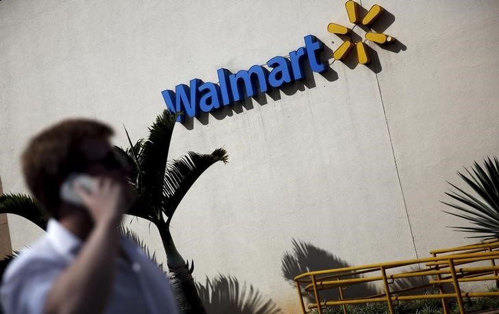 FILE PHOTO - A man talks on his mobile phone in front of a Wal-Mart store in Sao Paulo