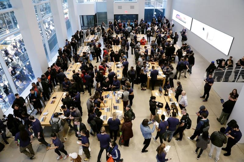 Customers arrive to purchase an iPhone X at an Apple store in New York
