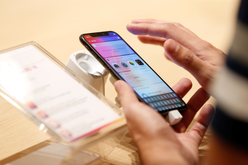 A customer tests the features of the newly launched iPhone X at VIVA telecommunication store in Manama