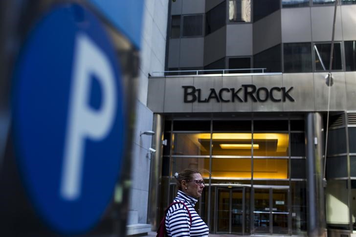 FILE PHOTO: A woman walks next to a BlackRock sign pictured in the Manhattan borough of New York