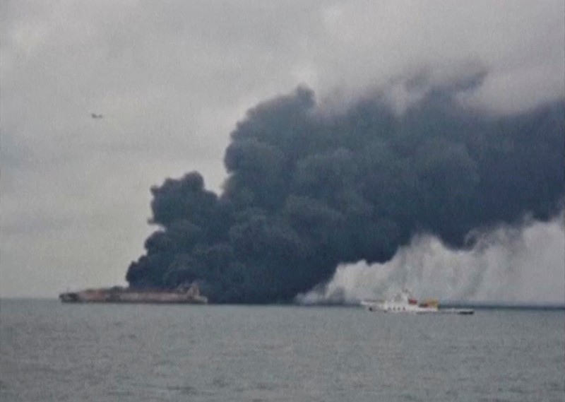 Smoke is seen from Panama-registered tanker Sanchi carrying Iranian oil after it collided with a Chinese freight ship in the East China Sea