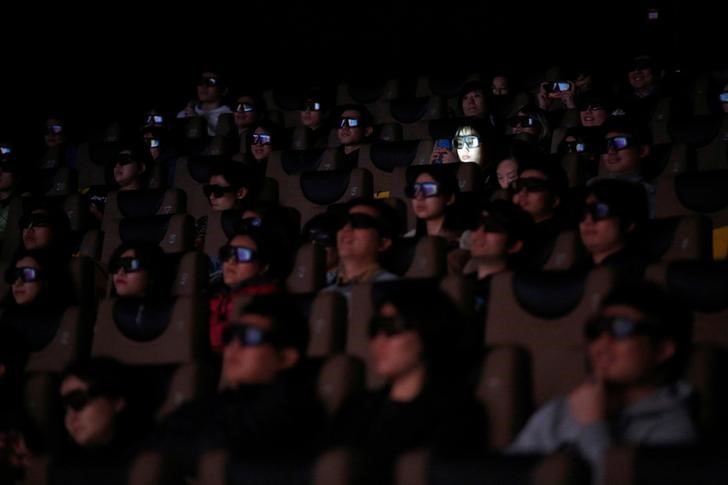 FILE PHOTO: People wearing 3D glasses watch the movie 