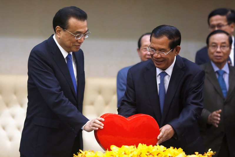 Chinese Premier Li Keqiang and CambodiaÕs Prime Minister Hun Sen stand as they hold bilateral talks in Phnom Penh, Cambodia